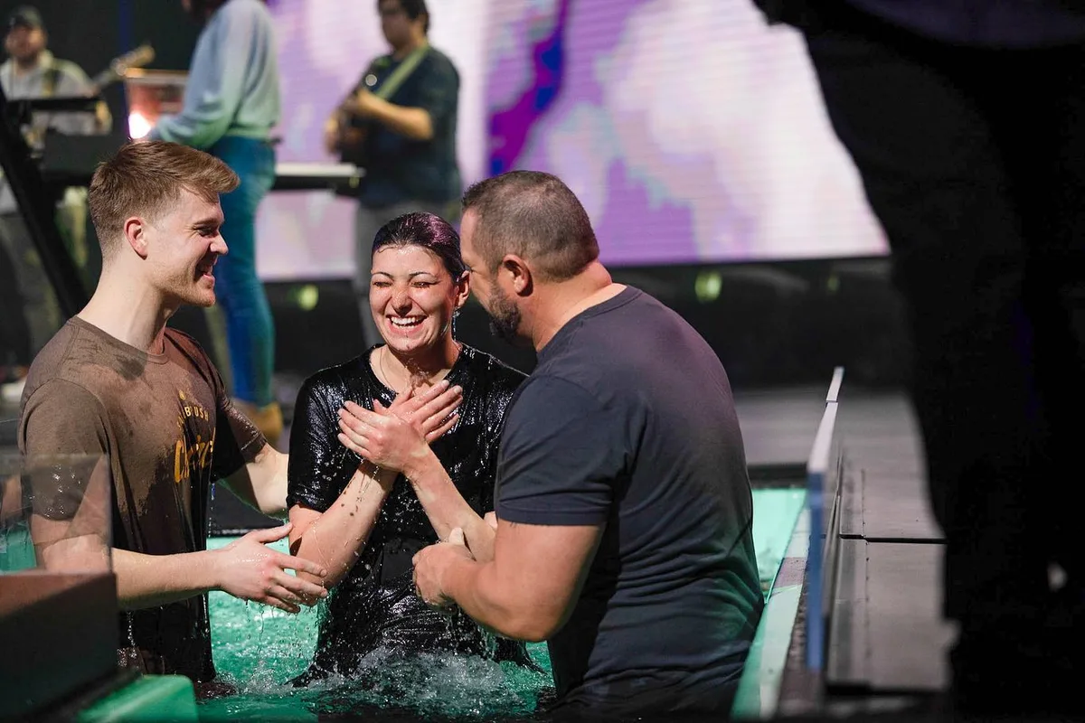 A person smiles after being baptized during a Sagebrush service.