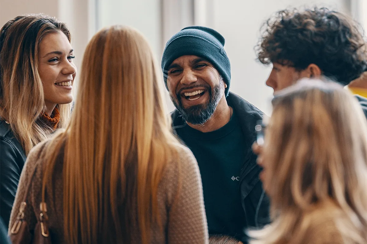 A smiling group of people connecting at Sagebrush
