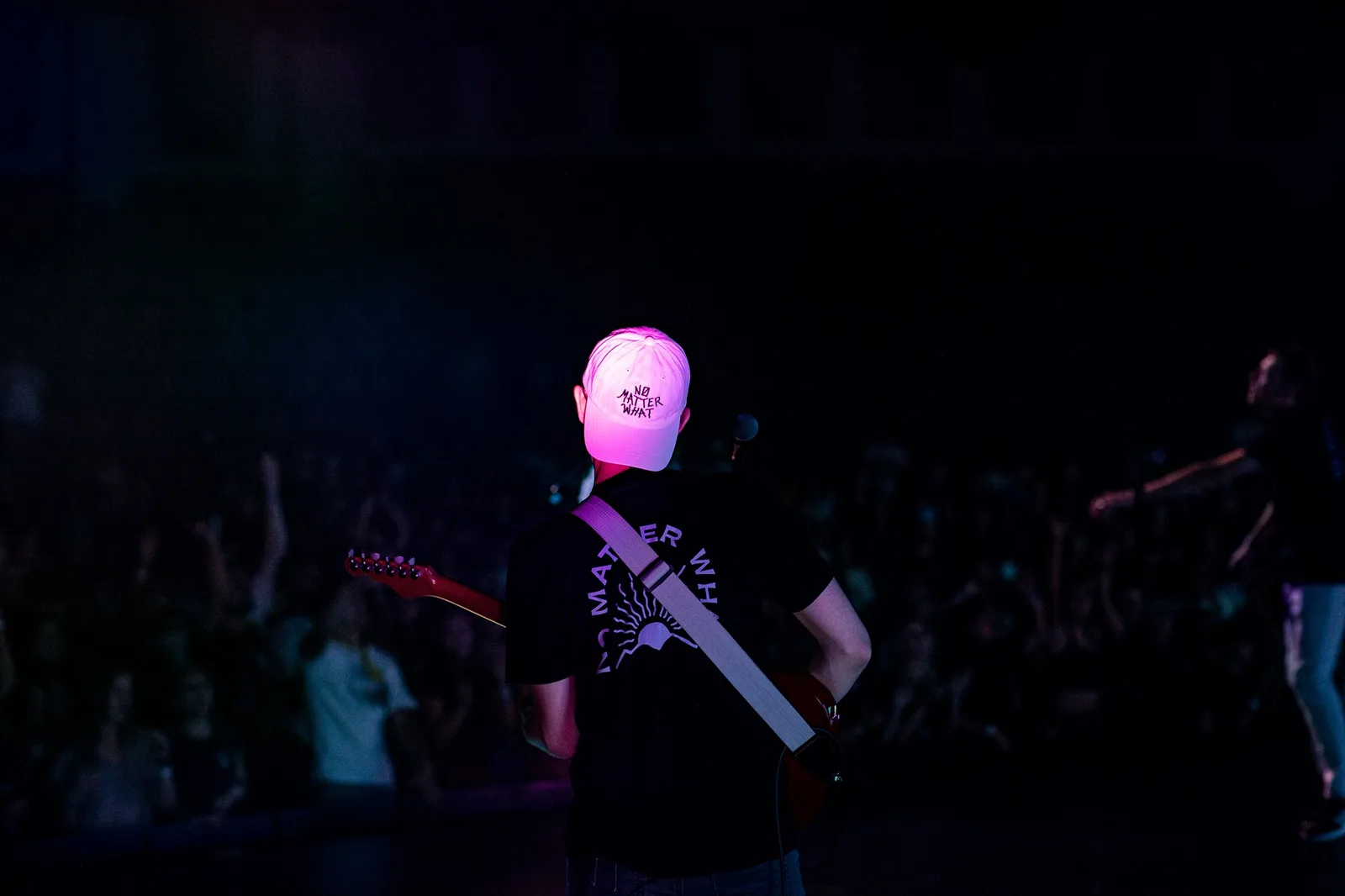 A student worship leader plays guitar during Remix.